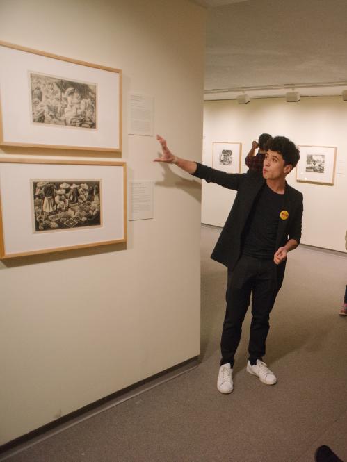 Student giving tour to group in an exhibition